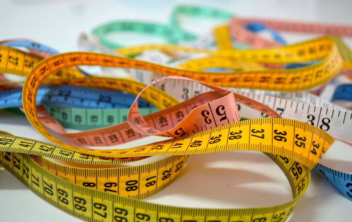 Close-up of drafting tool measuring tape how to showing precise scale markings and rigid blade design